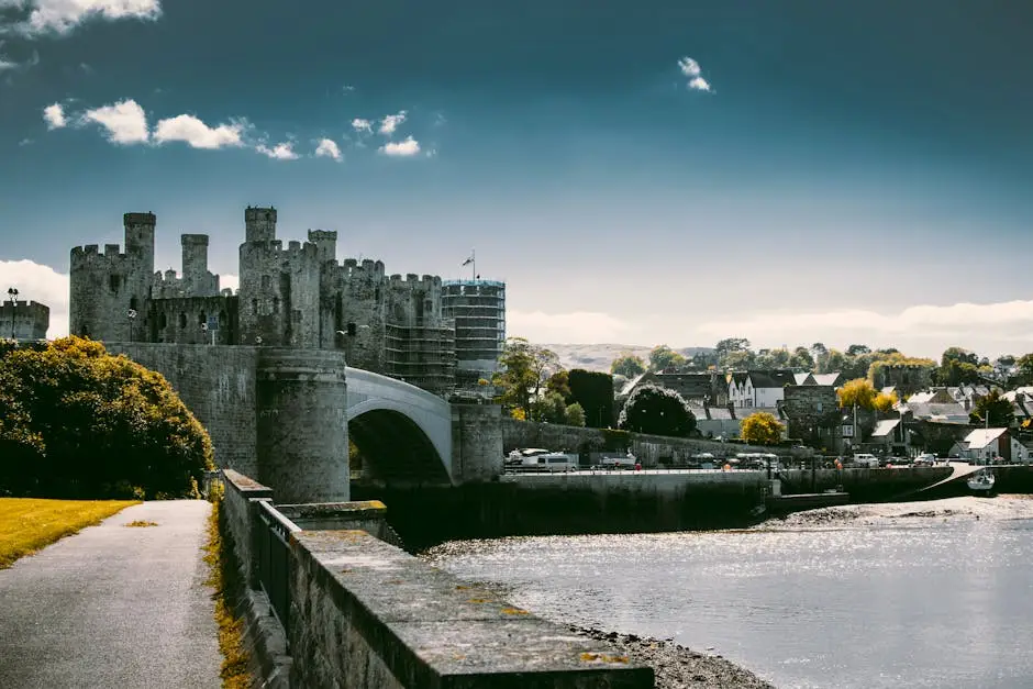 A captivating shot of the historic Conwy Castle and bridge under a vibrant sky in Wales.